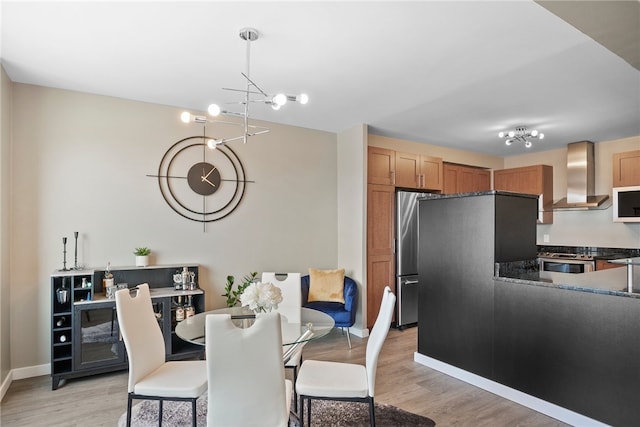 dining room featuring light hardwood / wood-style flooring and a chandelier