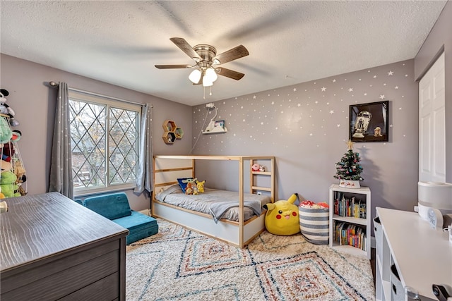 bedroom with carpet flooring, a textured ceiling, and ceiling fan