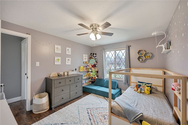 bedroom with a textured ceiling, ceiling fan, and dark wood-type flooring