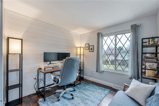 office featuring wood walls, plenty of natural light, and dark hardwood / wood-style floors