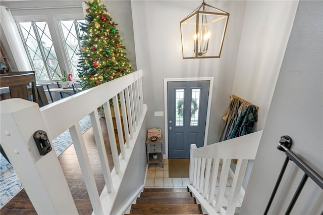 entryway featuring dark hardwood / wood-style flooring and a chandelier