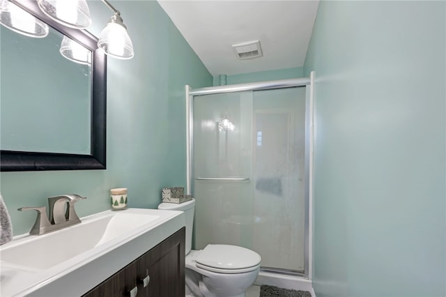 bathroom featuring vanity, toilet, and walk in shower