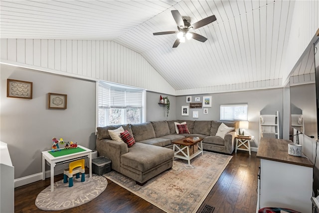 living room featuring dark hardwood / wood-style floors, ceiling fan, a wealth of natural light, and vaulted ceiling