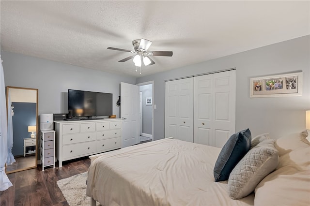 bedroom with a textured ceiling, a closet, ceiling fan, and dark wood-type flooring