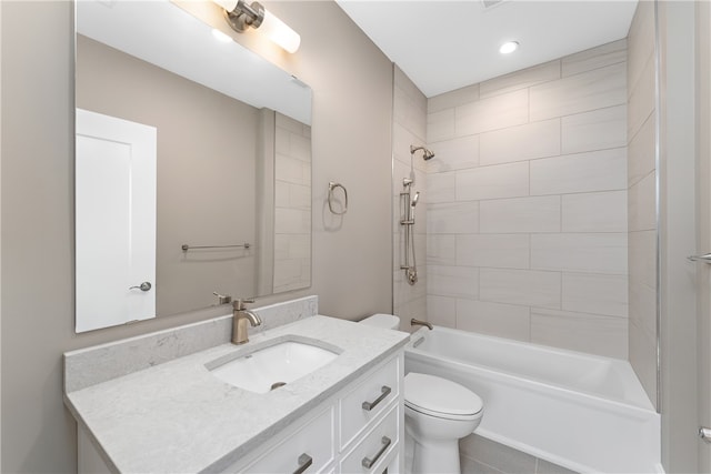 full bathroom featuring tiled shower / bath combo, toilet, and vanity