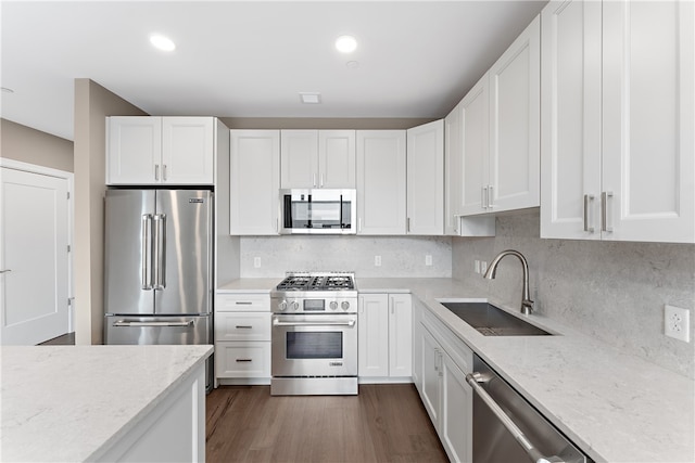 kitchen featuring white cabinets, dark hardwood / wood-style floors, high end appliances, and sink