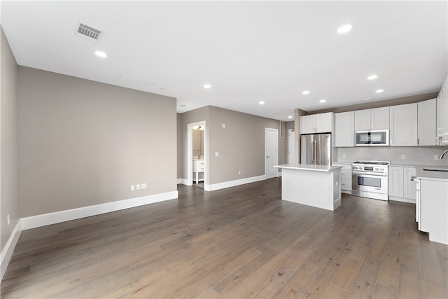 kitchen featuring white cabinetry, dark hardwood / wood-style flooring, a kitchen island, and high end appliances