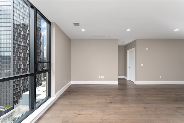 empty room with hardwood / wood-style floors