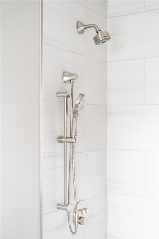 interior details featuring tiled shower