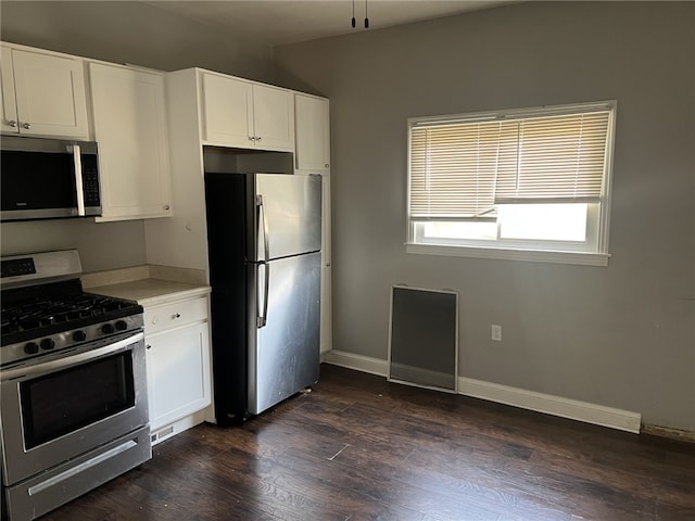 kitchen featuring white cabinets, stainless steel appliances, and dark hardwood / wood-style floors