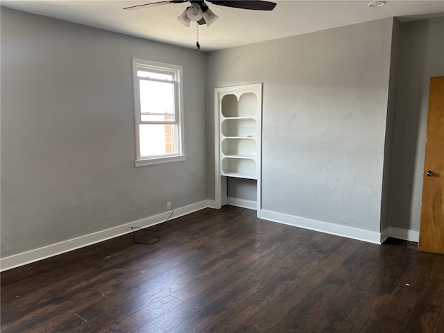 unfurnished room with dark hardwood / wood-style flooring and ceiling fan