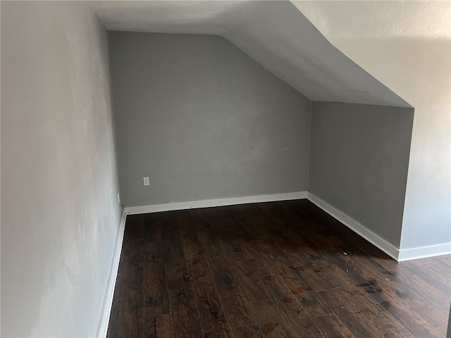 bonus room featuring dark hardwood / wood-style floors and lofted ceiling