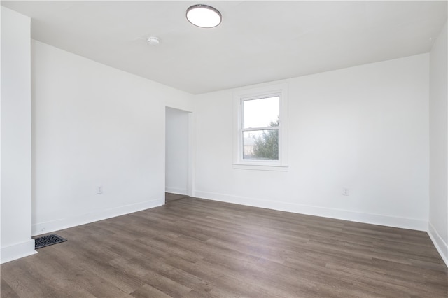 empty room featuring dark wood-type flooring