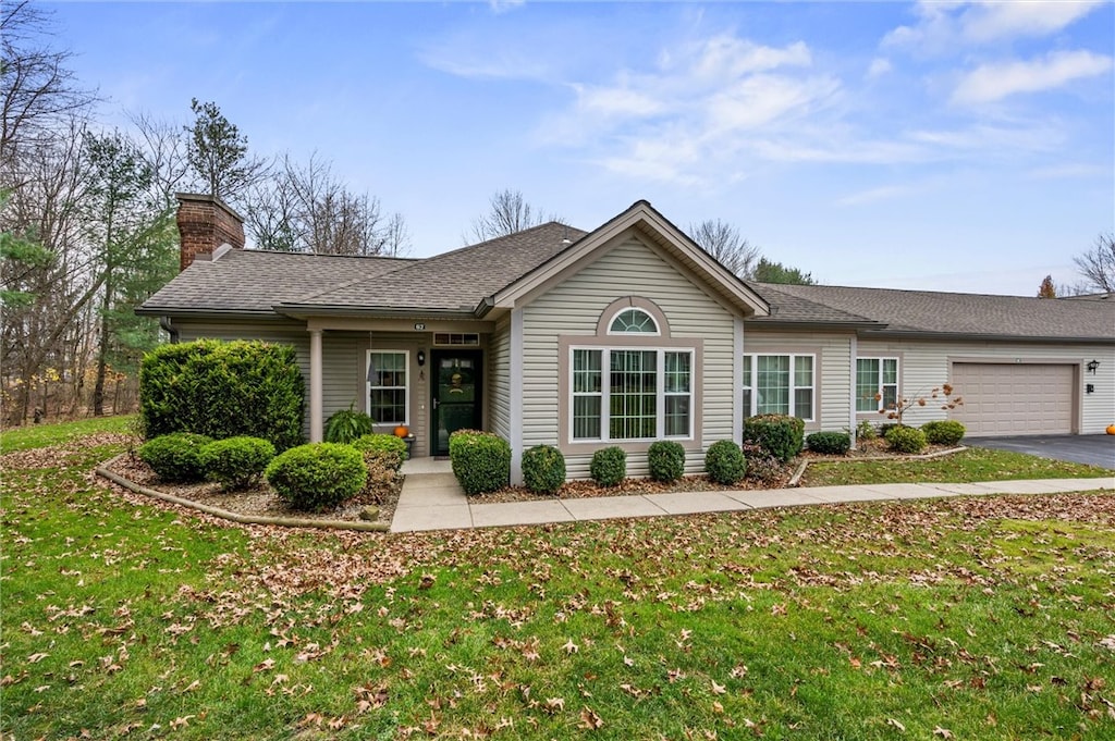 ranch-style home with a front yard and a garage