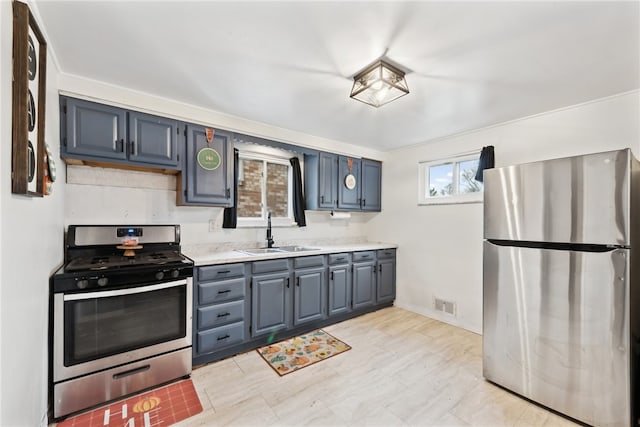 kitchen with appliances with stainless steel finishes, ornamental molding, and sink