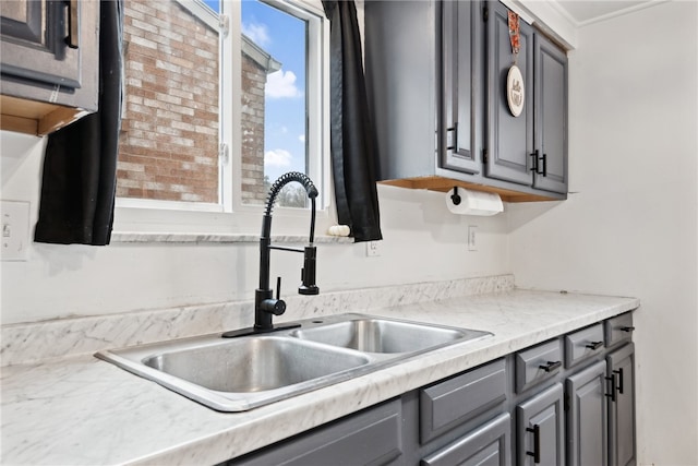 kitchen featuring gray cabinetry and sink