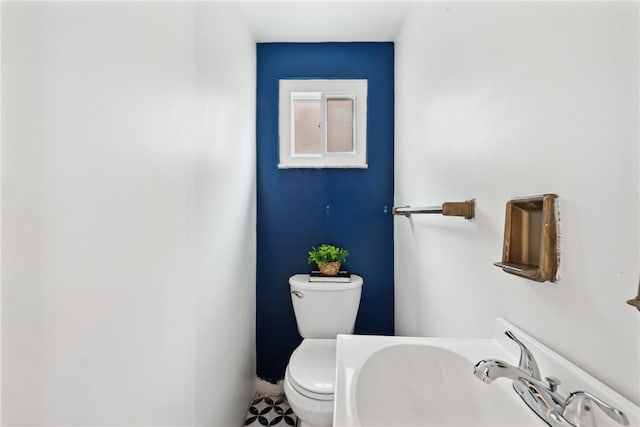 bathroom with tile patterned flooring, toilet, and sink