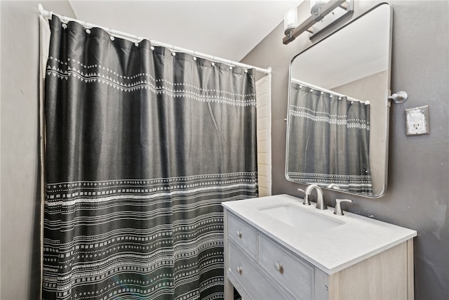 bathroom featuring curtained shower and vanity