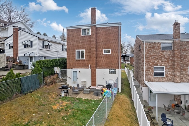 back of house with a yard, a patio, and central AC