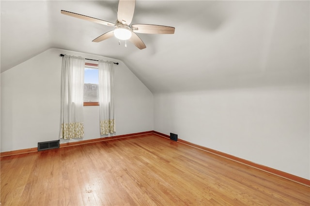 additional living space with ceiling fan, light hardwood / wood-style flooring, and vaulted ceiling