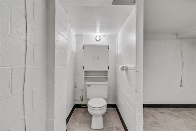 bathroom with concrete flooring and toilet