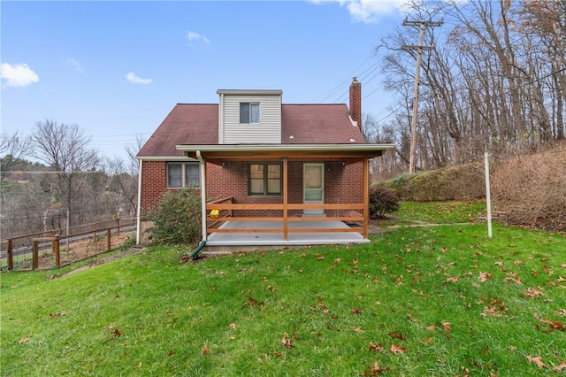 rear view of house with a lawn and a wooden deck