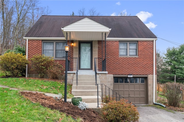 view of front of house with a garage and a front lawn