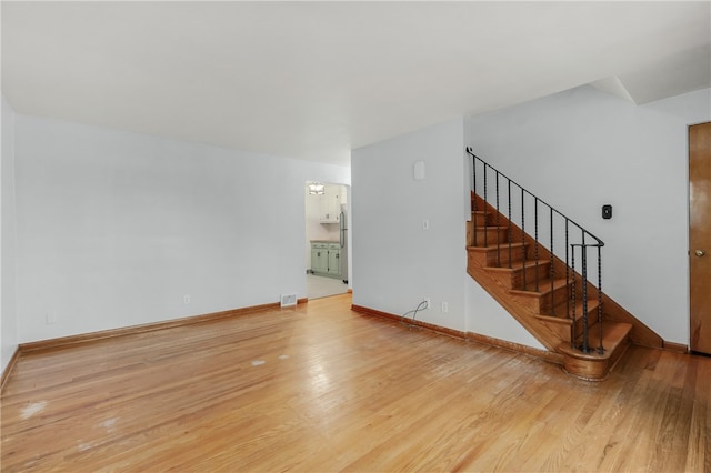 unfurnished living room featuring wood-type flooring