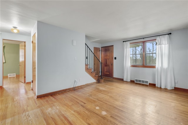 unfurnished room with light hardwood / wood-style flooring