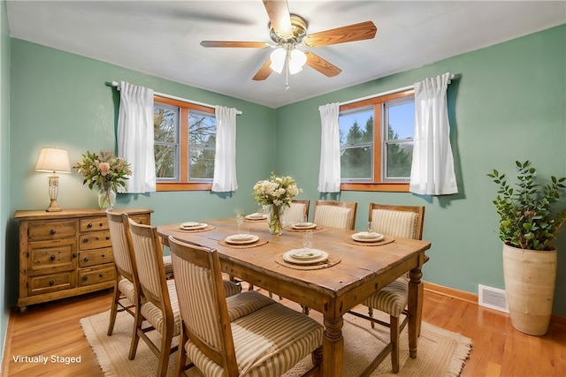 dining space with ceiling fan and light hardwood / wood-style floors