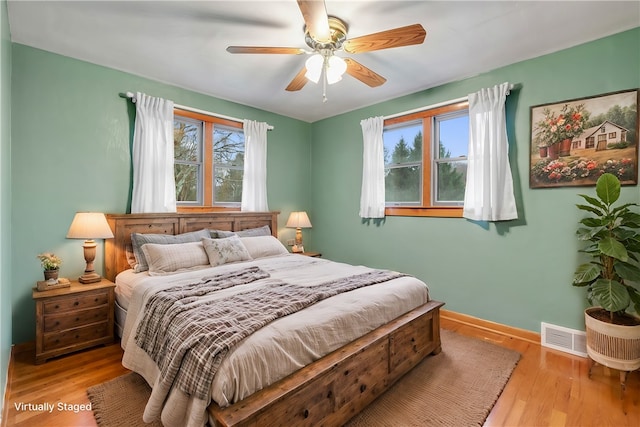 bedroom with ceiling fan and light wood-type flooring