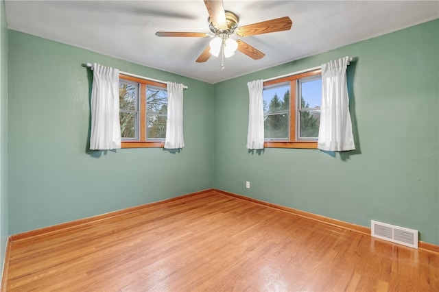 spare room with light wood-type flooring and ceiling fan