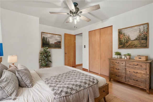 bedroom with ceiling fan, a closet, and light hardwood / wood-style flooring