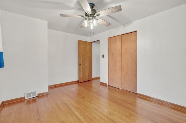 unfurnished bedroom featuring a closet, ceiling fan, and light hardwood / wood-style flooring