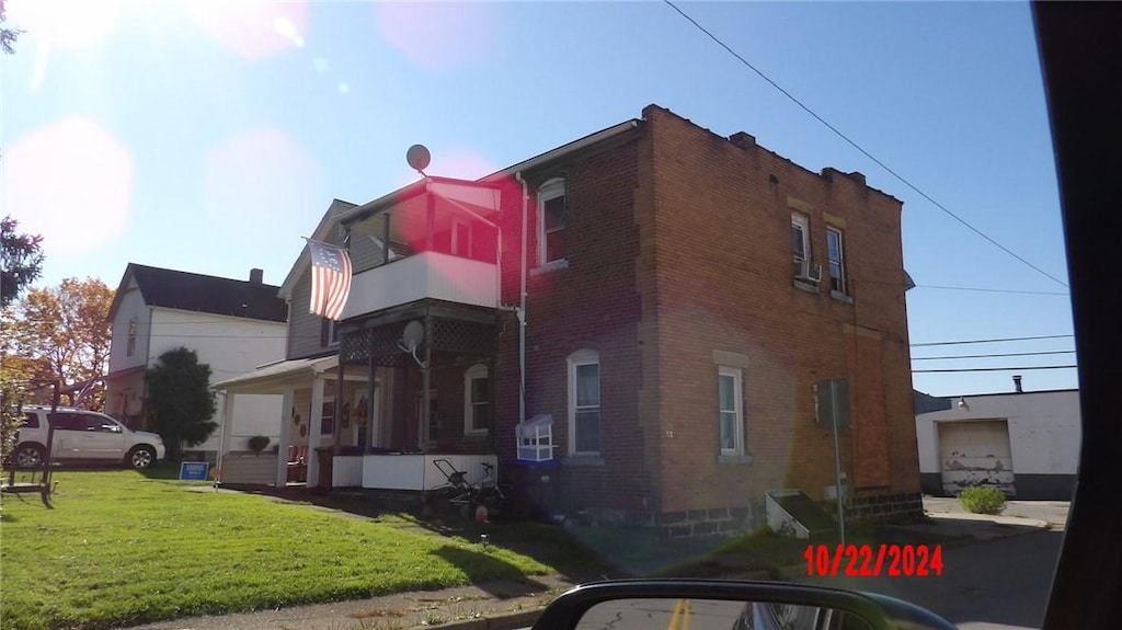 647 Hamilton Ave, Farrell, PA 16121 - view of side of property with a balcony, brick siding, and a lawn