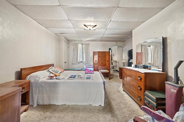 bedroom featuring a paneled ceiling and light colored carpet