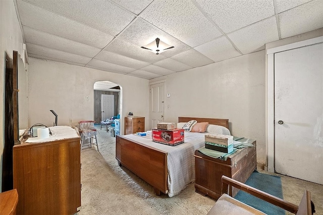 carpeted bedroom with a paneled ceiling