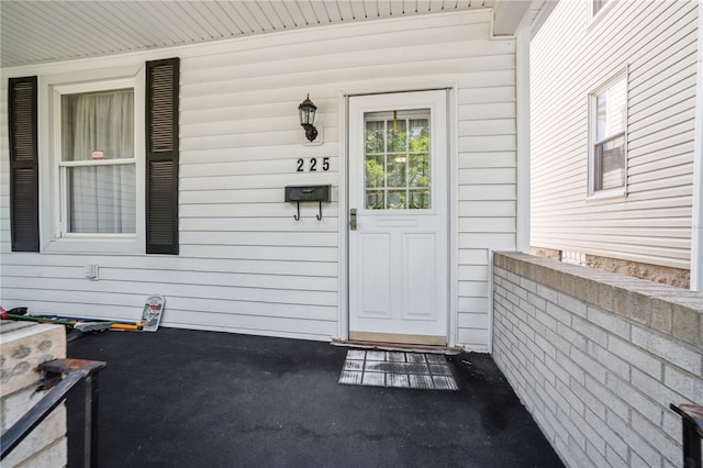 view of exterior entry with a porch