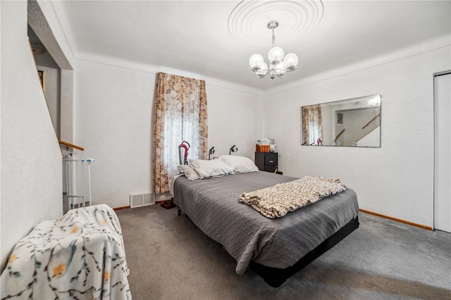 bedroom with carpet floors and a chandelier