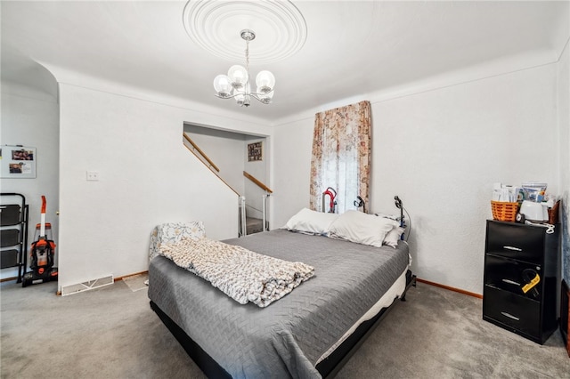 bedroom featuring carpet flooring and a chandelier