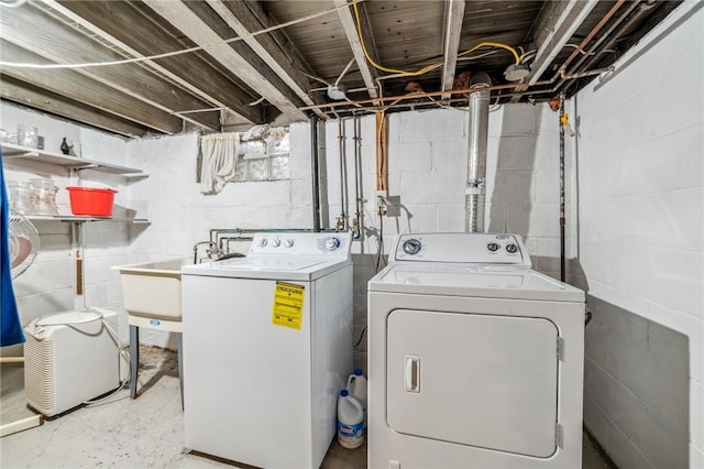 washroom featuring washing machine and clothes dryer and sink