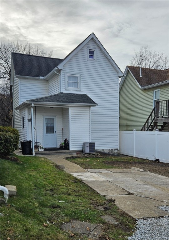 back of house with a yard and central AC unit