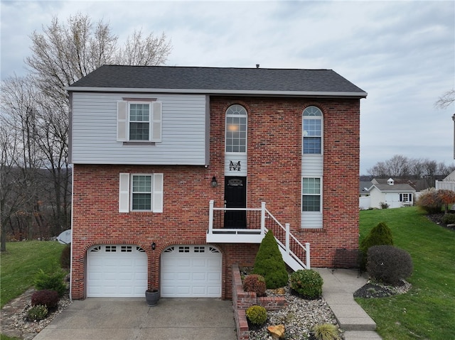 view of front of property featuring a front yard and a garage