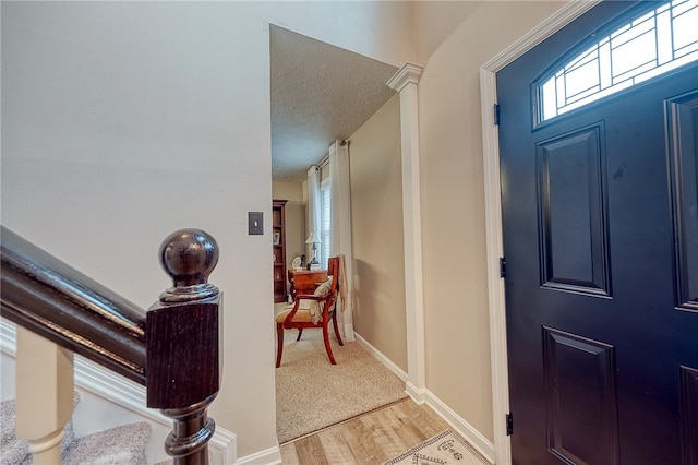 foyer featuring a textured ceiling and light wood-type flooring