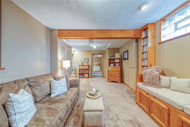 carpeted living room featuring beam ceiling and a textured ceiling