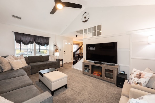 living room featuring ceiling fan, carpet, and high vaulted ceiling