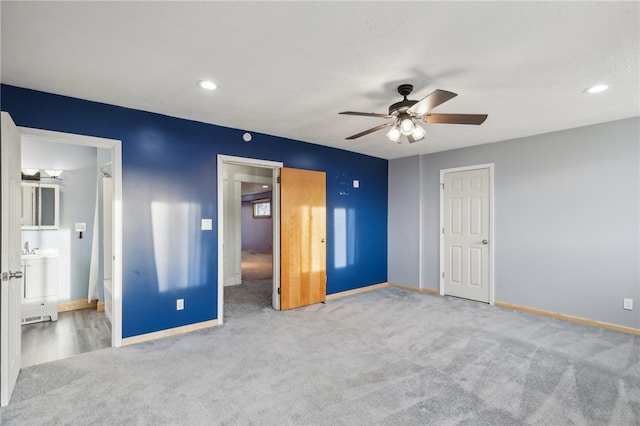 unfurnished bedroom with carpet flooring, ensuite bath, and ceiling fan