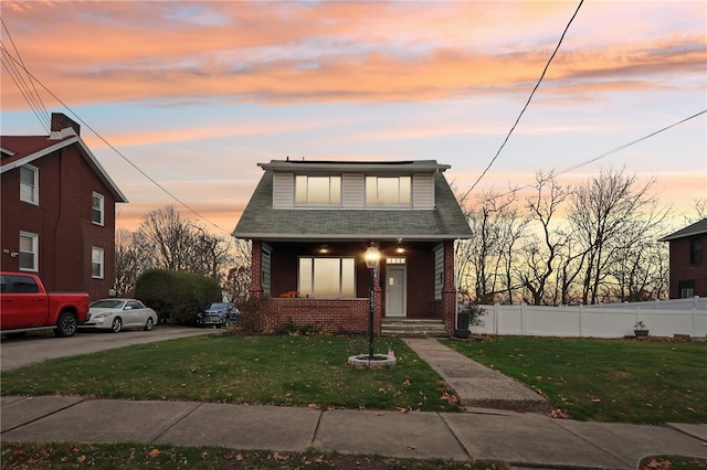 bungalow featuring a yard