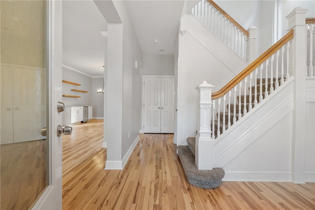 entryway featuring light hardwood / wood-style flooring and ornamental molding