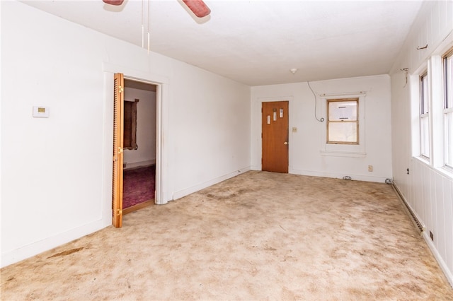 carpeted spare room with ceiling fan